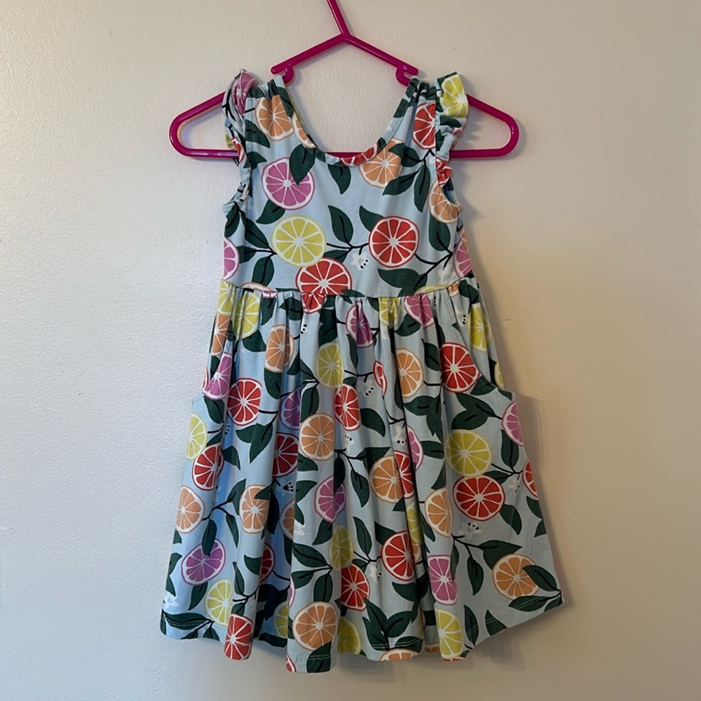 Hanna Andersson citrus cotton dress with pockets and ruffle sleeve details.